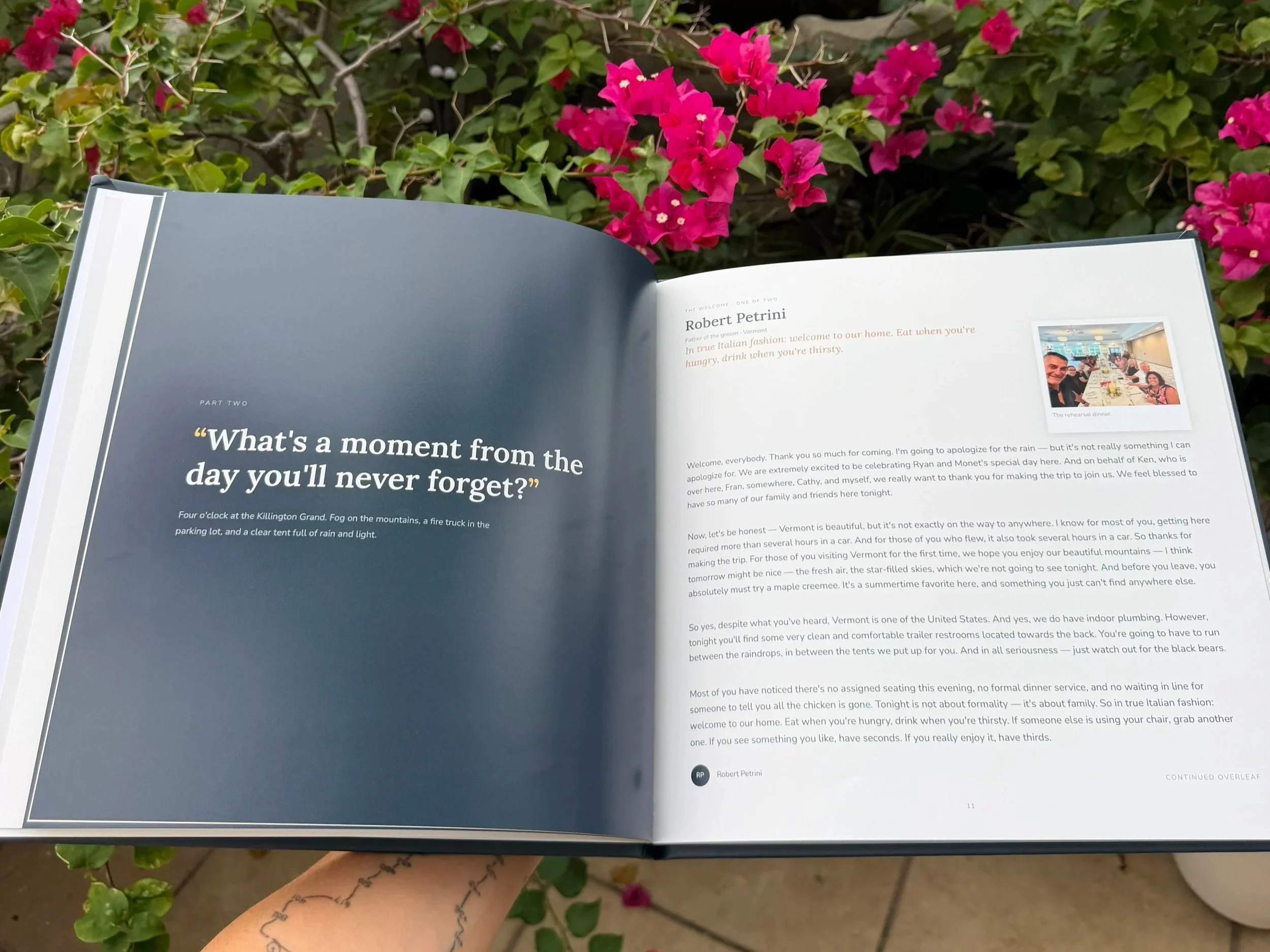 An open book held in front of pink bougainvillea flowers outdoors. The left page has text about the Killarney Grand and rainy weather; the right page contains text about Vermont, travel tips, and a small photo of a group dining indoors.