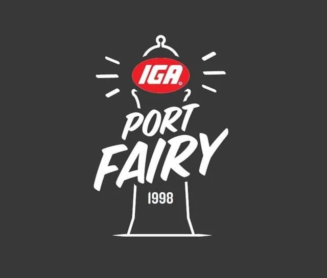 Logo for IGA Port Fairy with a stylized lighthouse and the year 1998 on a dark background.