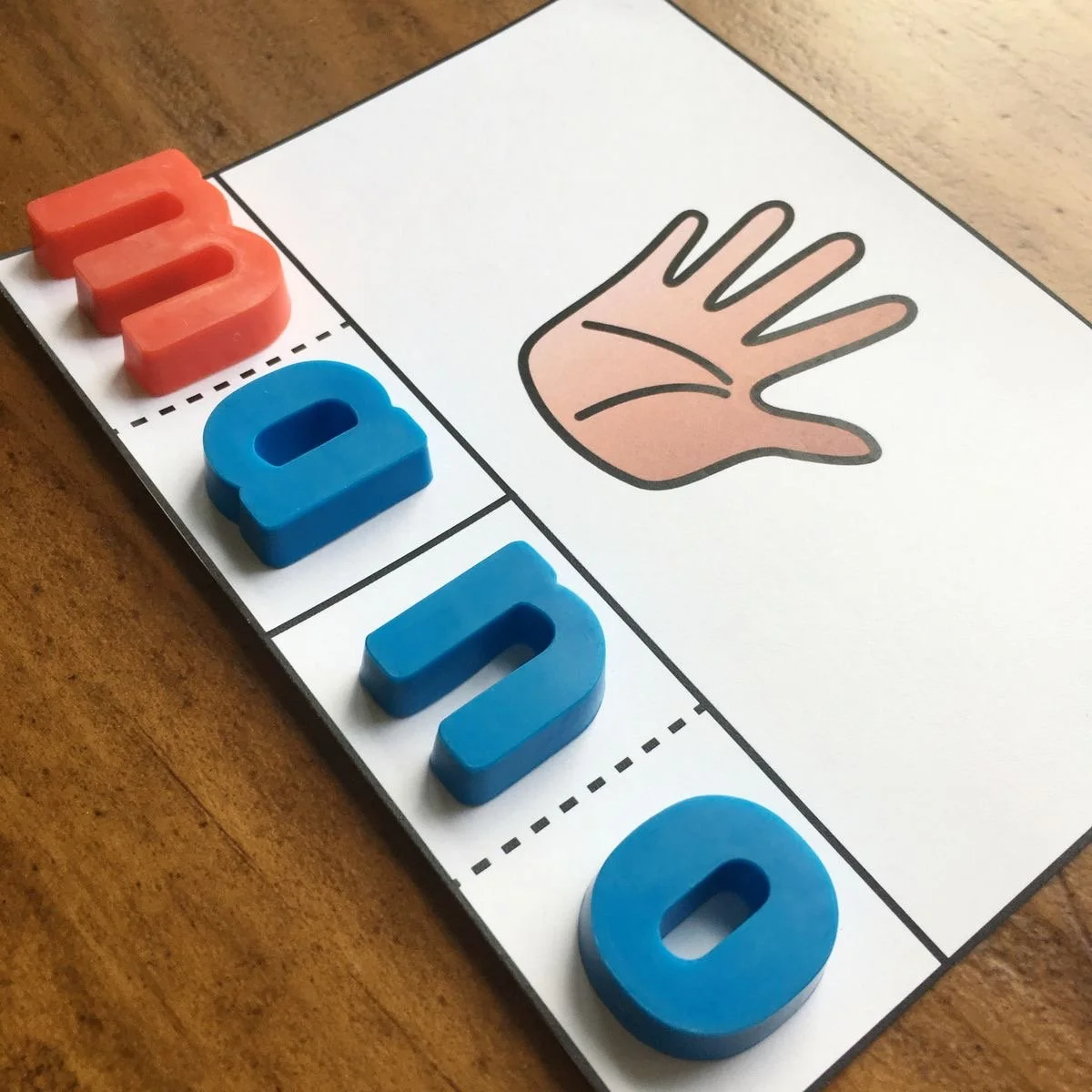 Educational chart with the word 'HUMAN' in colorful 3D letters and a drawing of a human hand.