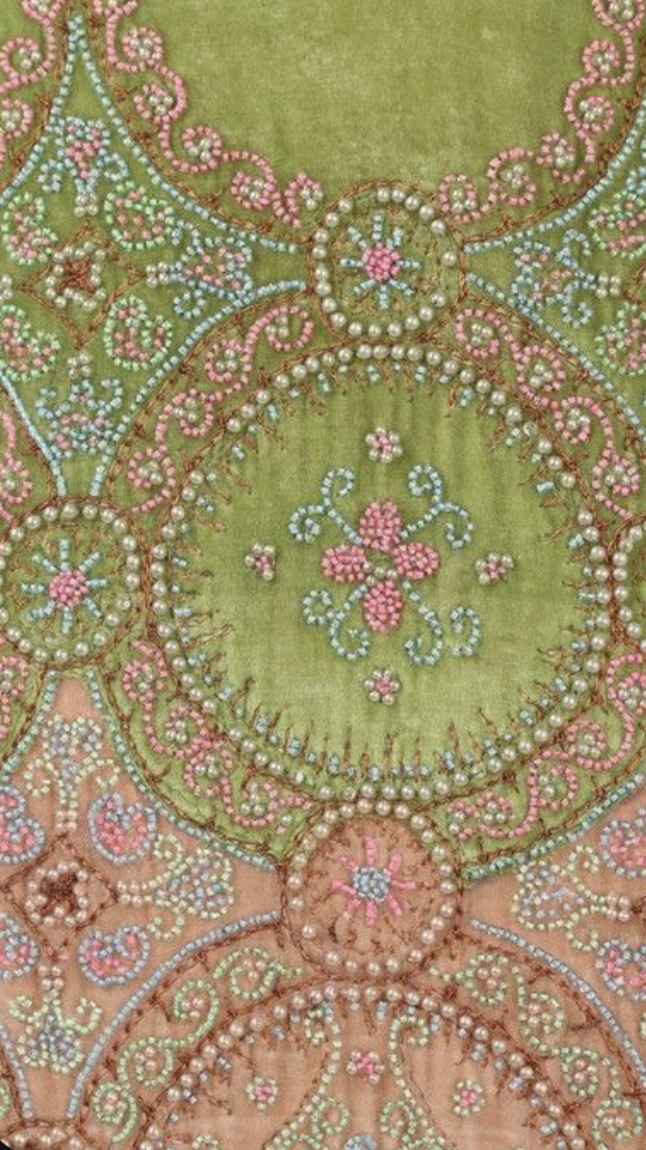 A Callot Soeurs couture beaded acid green velvet orientalist dress, circa 1923. un-labelled, the lower skirt of pale pink velvet embroidered and beaded in roundels, the scalloped hem with tasselled points, For a similar Callot Soeurs orientalist velv