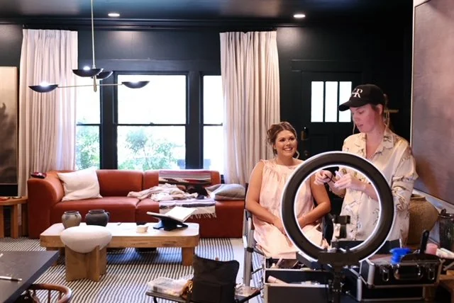 bride and her makeup artist with salterra collective laughing and talking morning of her wedding