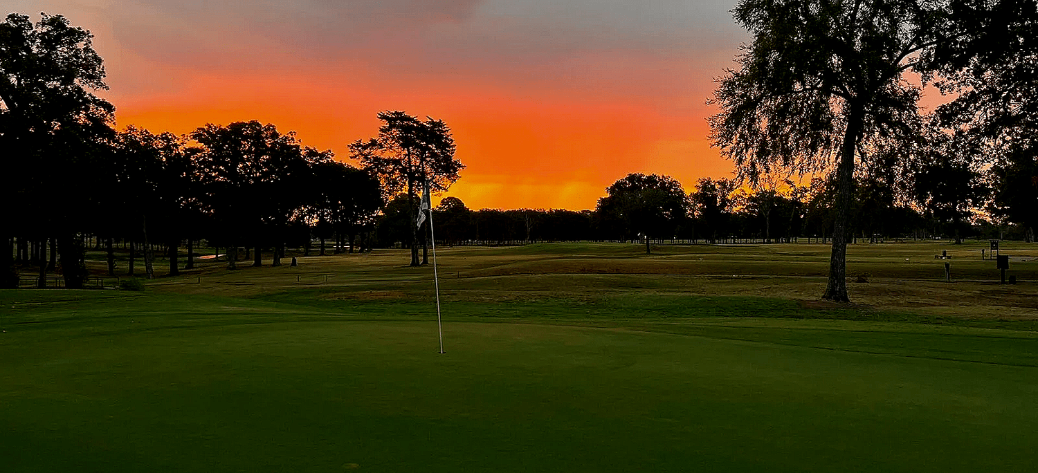 A golf course at sunset