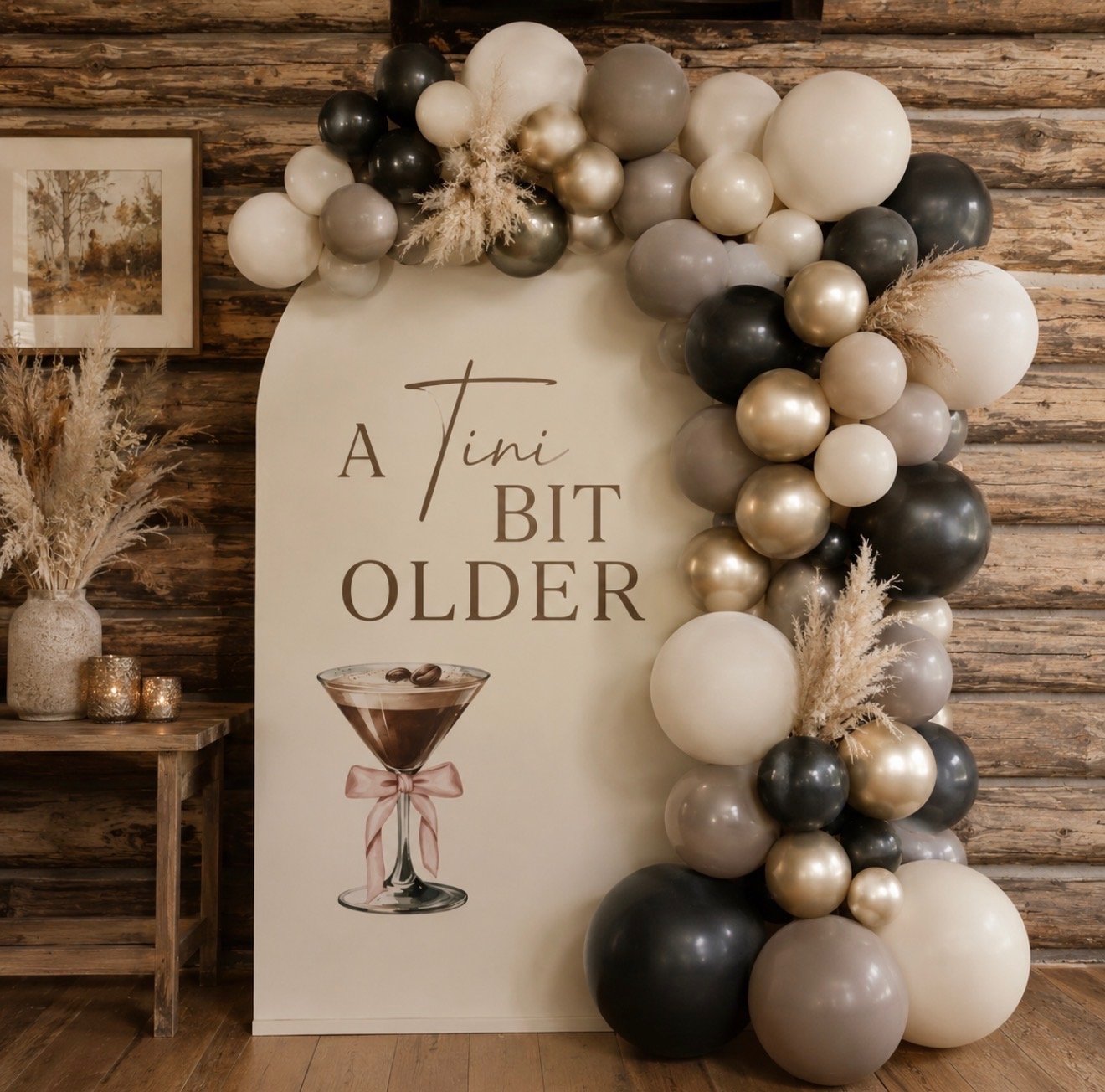 Custom birthday backdrop with neutral balloon garland and personalized espresso martini-themed signage