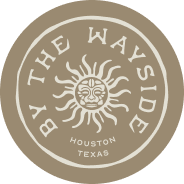 Logo with a stylized face or mask surrounded by the text 'The Wayside Houston Texas' on a beige background.