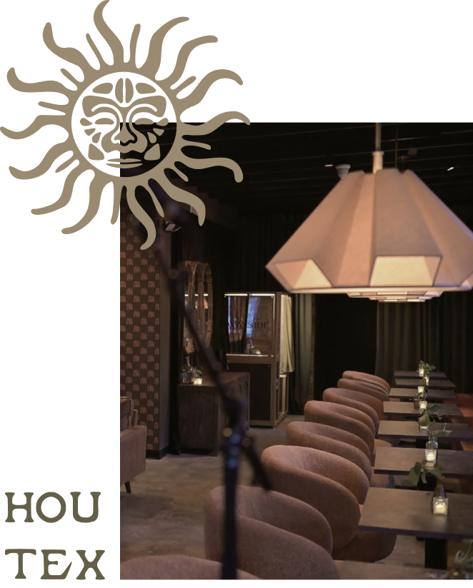 Cozy interior seating and ambient lighting at By The Wayside cocktail bar and date night spot in East End Houston