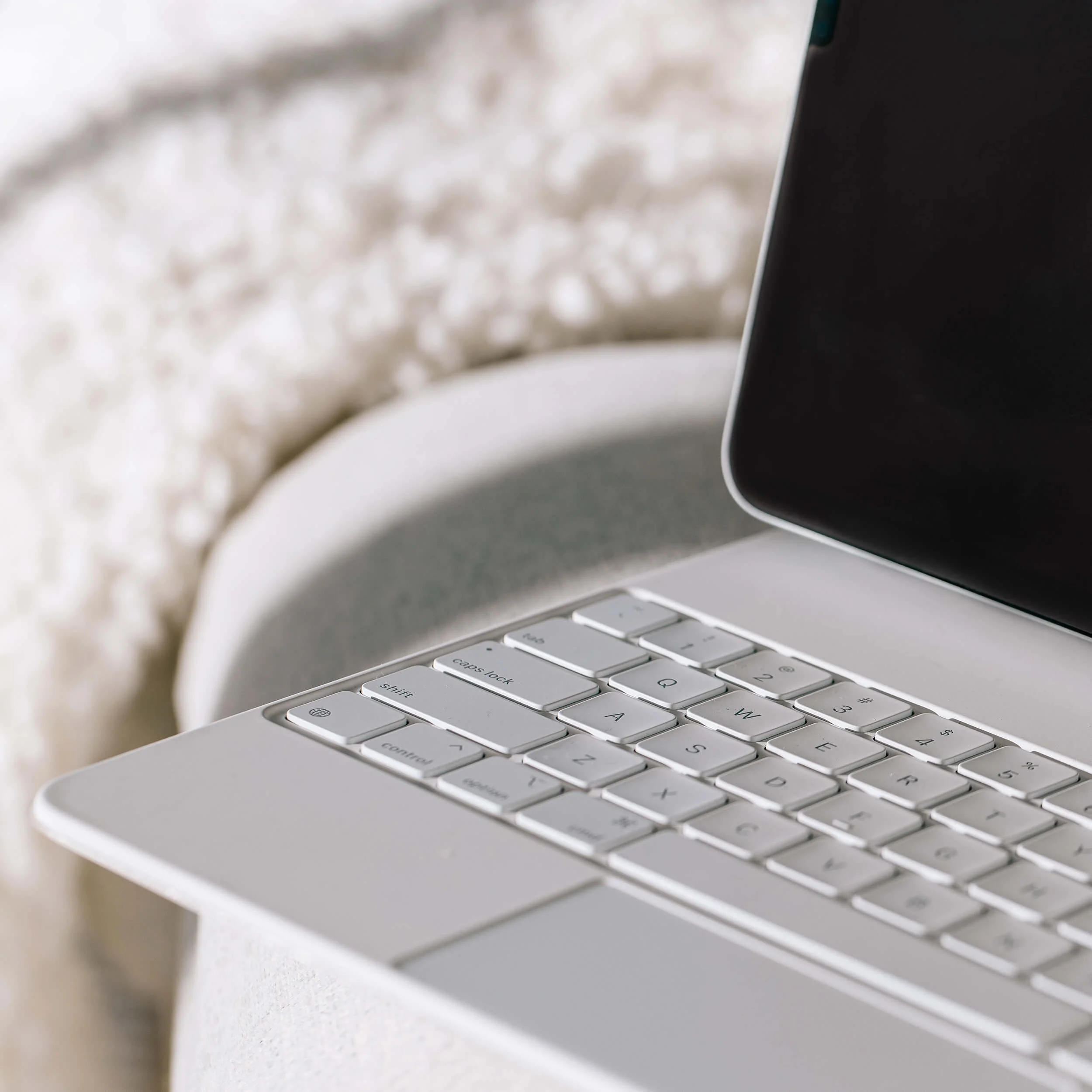 laptop on a bed corner