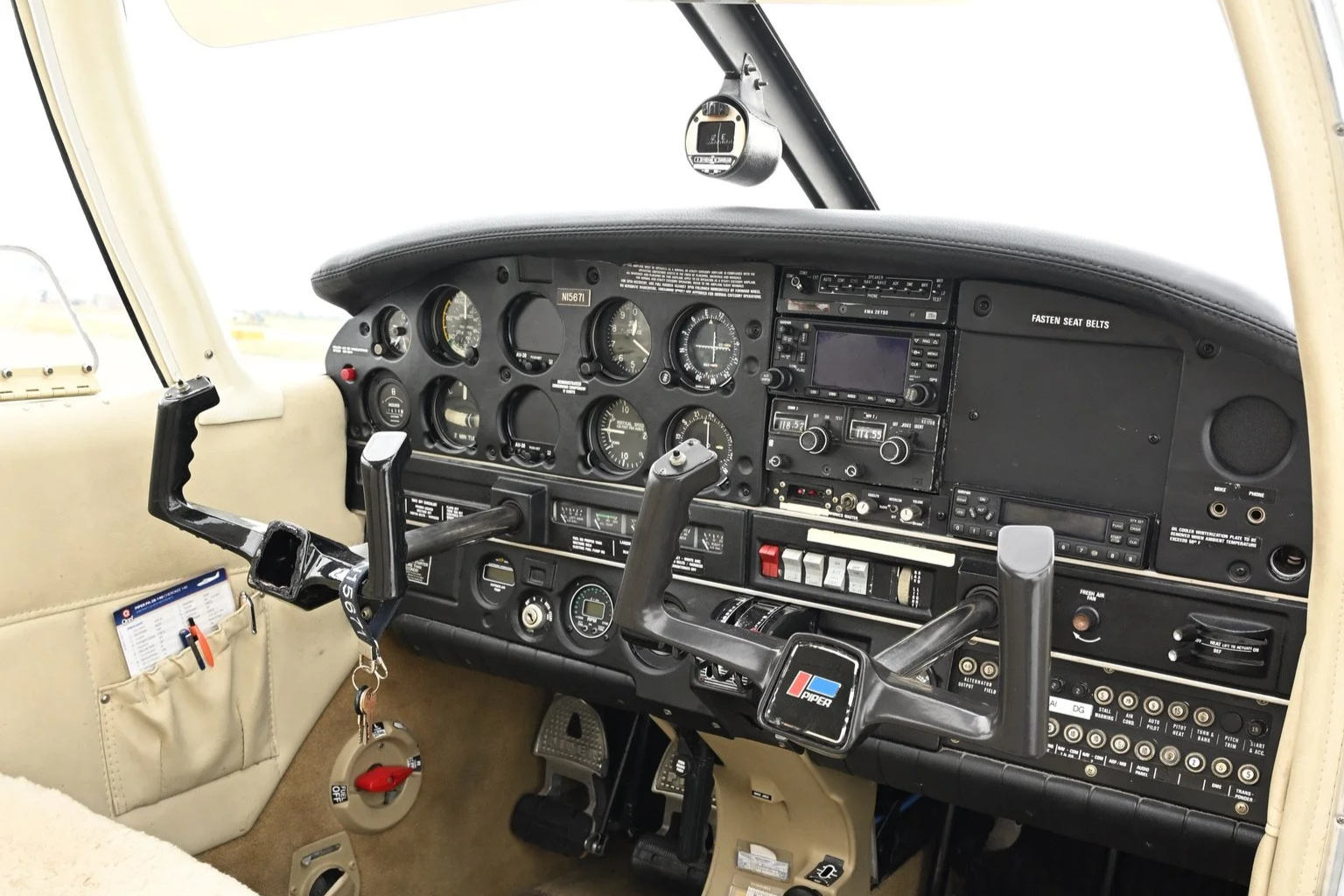 Aircraft cockpit interior with multiple analog gauges, control switches, and instrumentation panels.