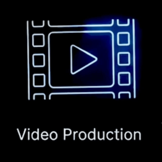 Neon sign of a film strip with a play button in the center, and the words "Video Production" below.