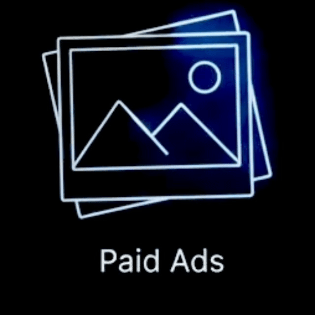 Neon outline of stacked photographs with a mountain and sun icon, labeled "Paid Ads" on a black background.