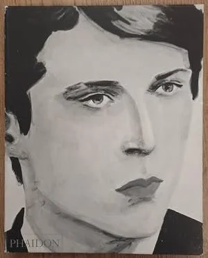 Black and white portrait of a young woman with short dark hair and a serious expression, looking to the side.