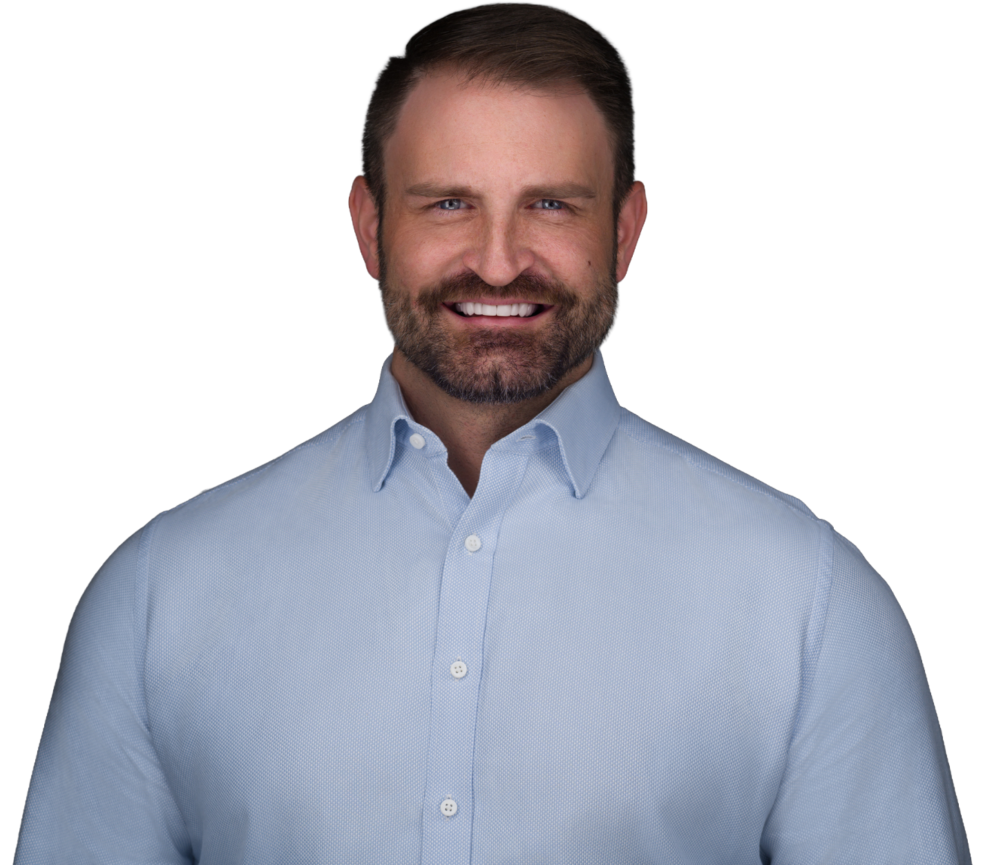 Headshot of a smiling man with short brown hair, beard, and blue eyes, wearing a light blue button-up shirt against a dark gray background.