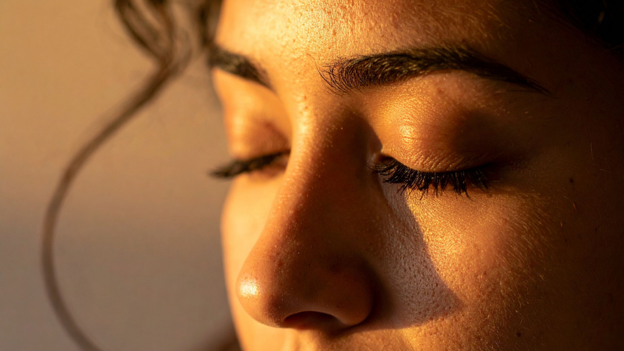   Close-up of healthy, glowing skin in warm natural light.