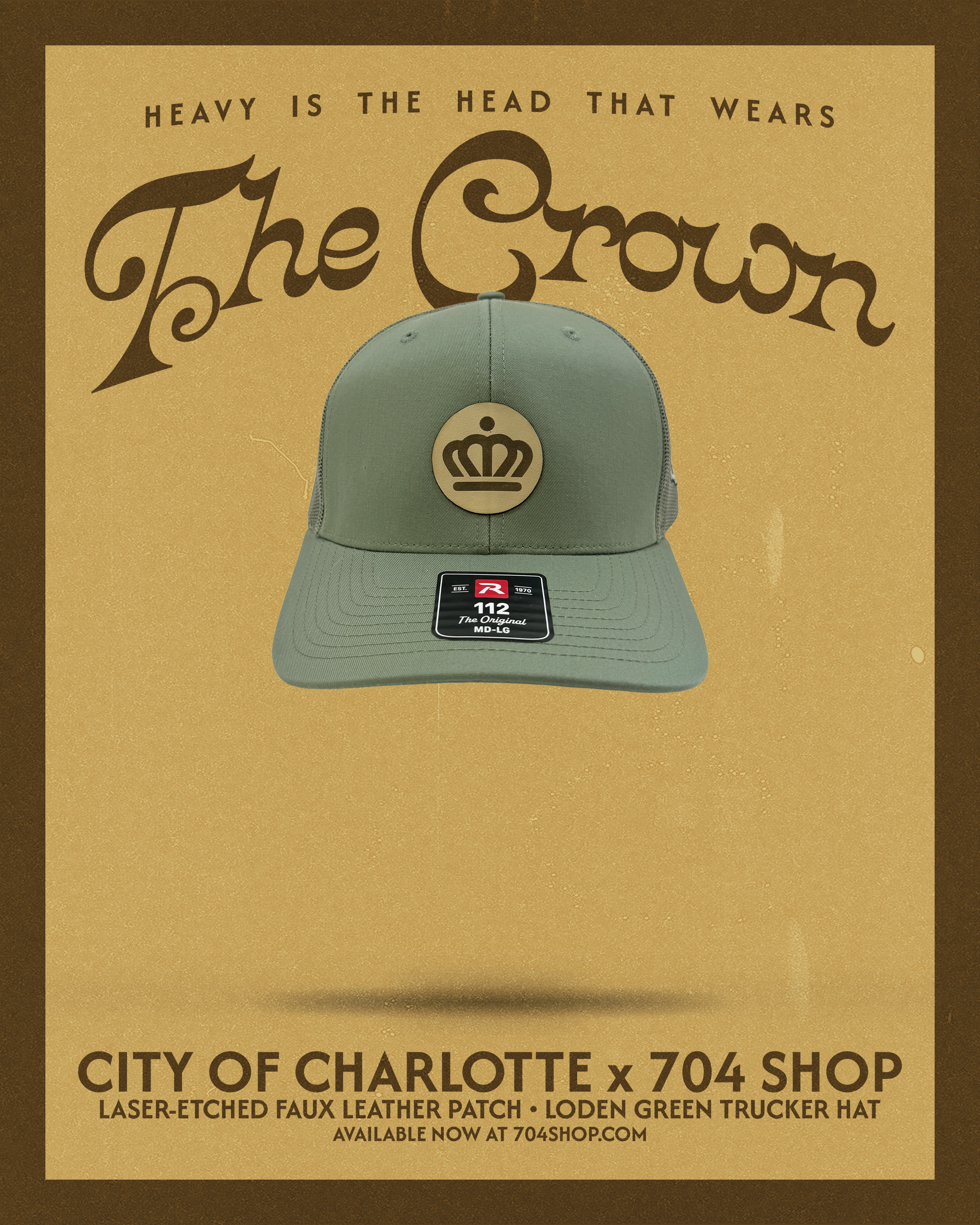 Green trucker hat with a gold crown emblem on the front, placed on a promotional poster for the City of Charlotte X 704 Shop, featuring a beige background and dark borders.