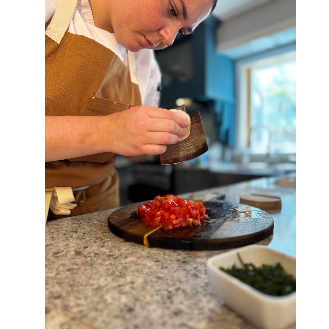 Chef Lizzie preparing fresh tomatoes for The Supper Club