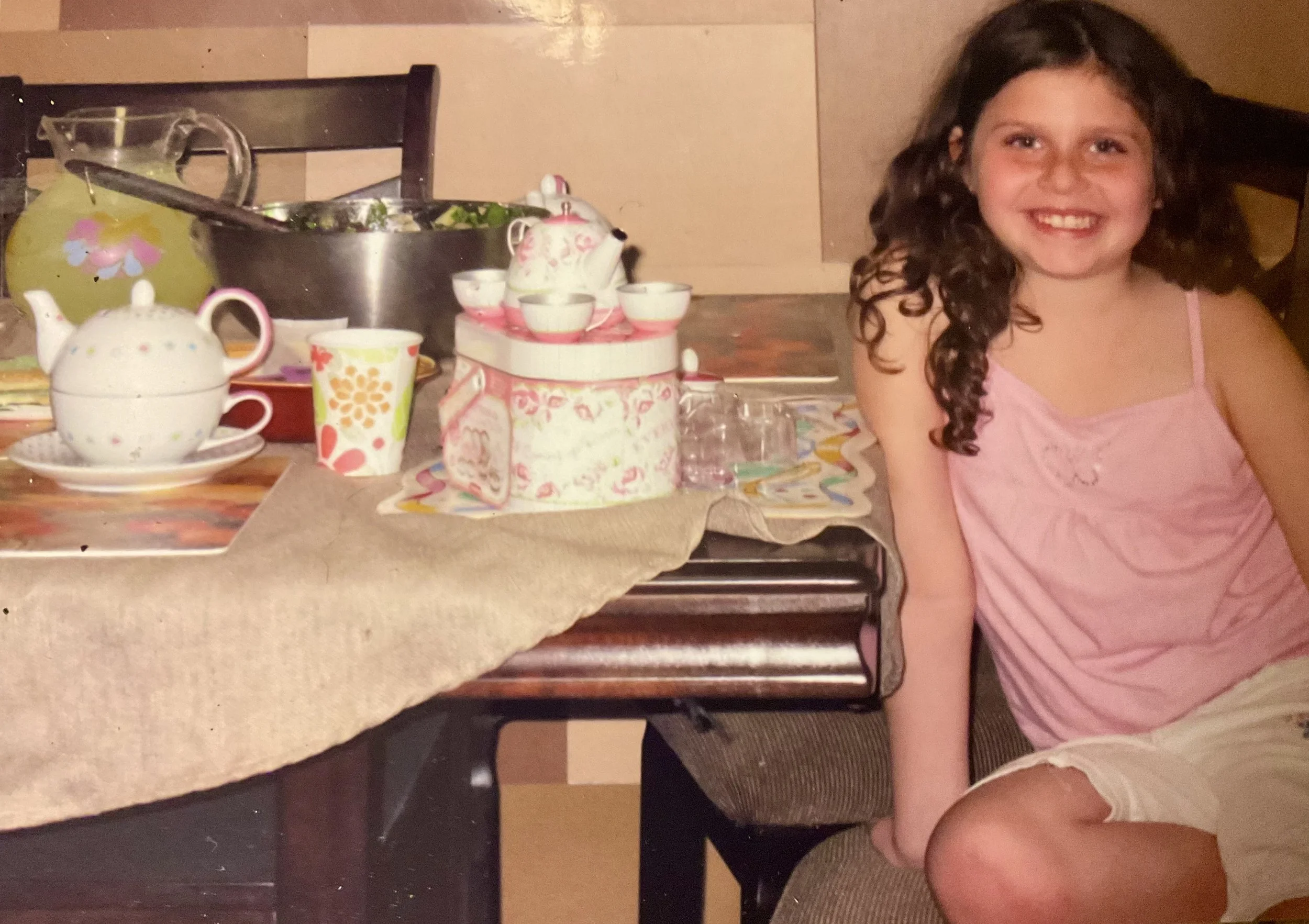 Chef Lizzie as a child enjoying a tea party