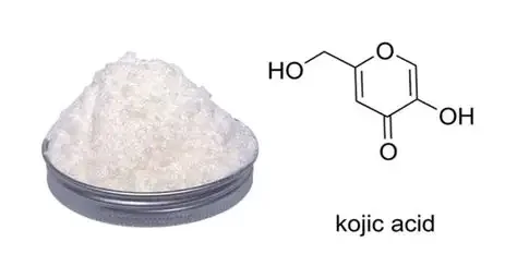 A bowl of white crystalline powder next to a chemical structure labeled 'kojic acid'.