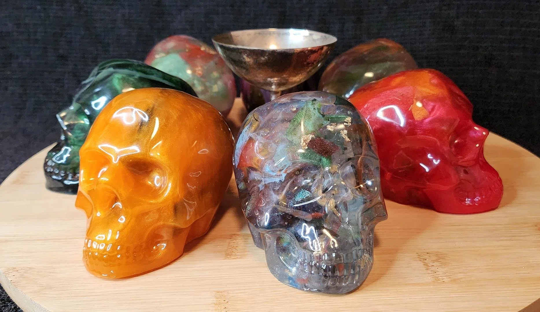 Several Examples of Anti-Waste JoaraCrafts decorative skulls. In this picture you can see skulls around a silver goblet for scale. All skulls are approx 6 centimeters wide by 10 centimeters height. The goblet is slightly taller, but not as wide. The 