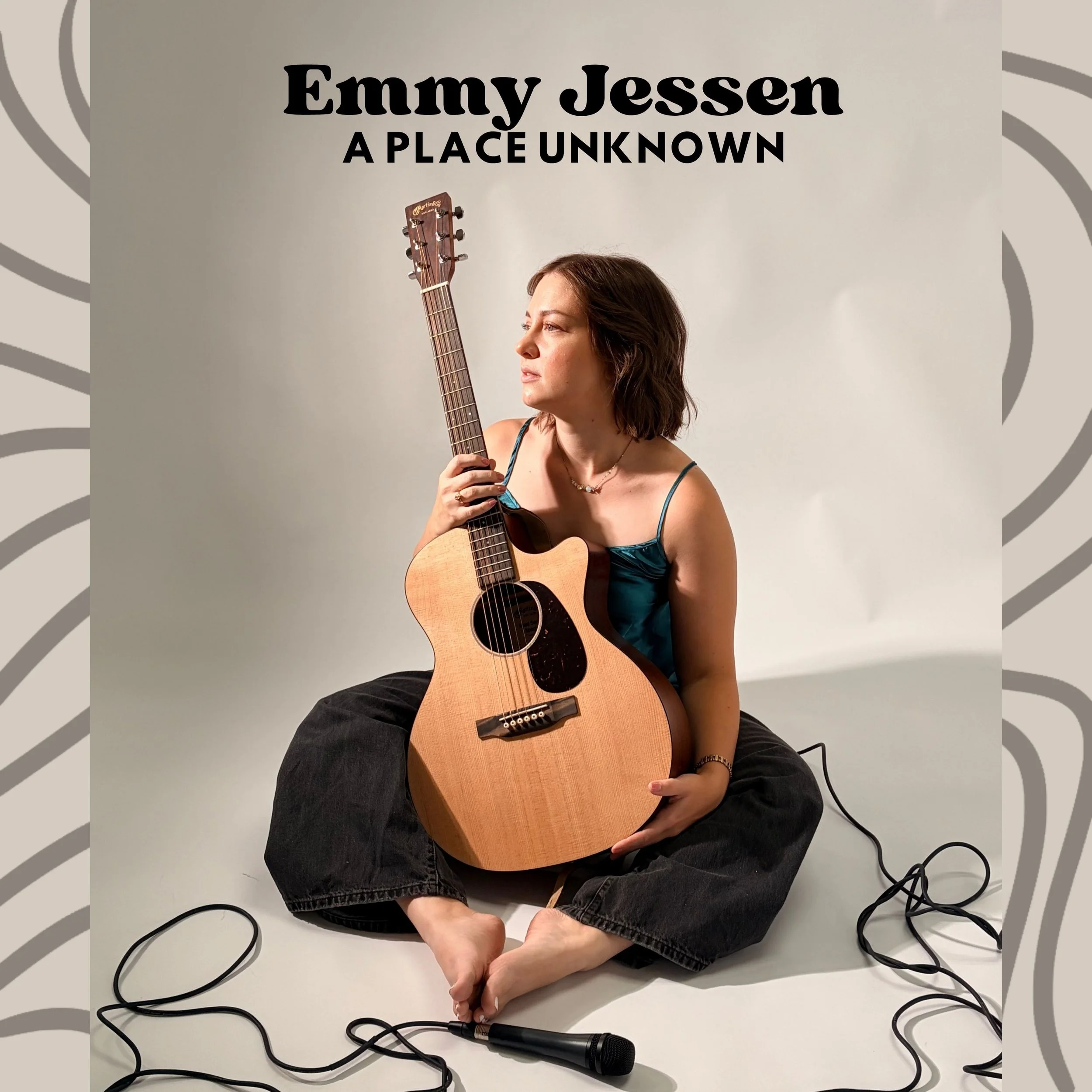 Emmy Jessen promotional artwork for the single A Place Unknown featuring the singer with her acoustic guitar, microphone, and recording cables.