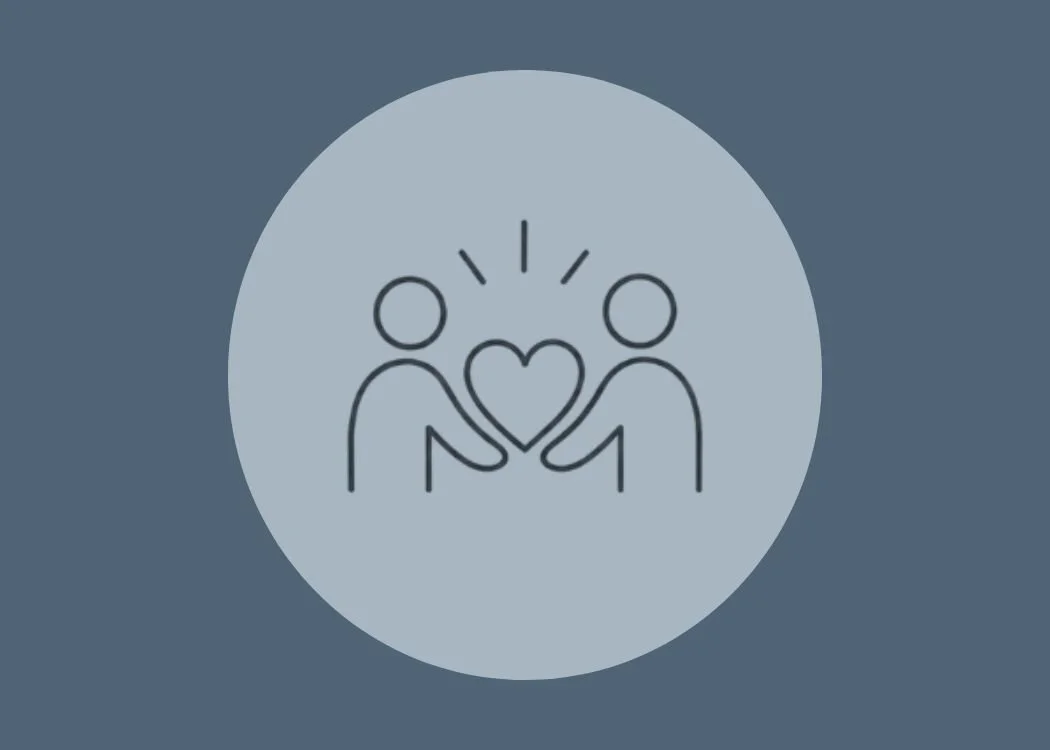 A simple line drawing of two people exchanging a heart with radiating lines above their heads.