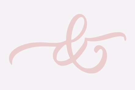 A pink, cursive ampersand symbol on a light background.