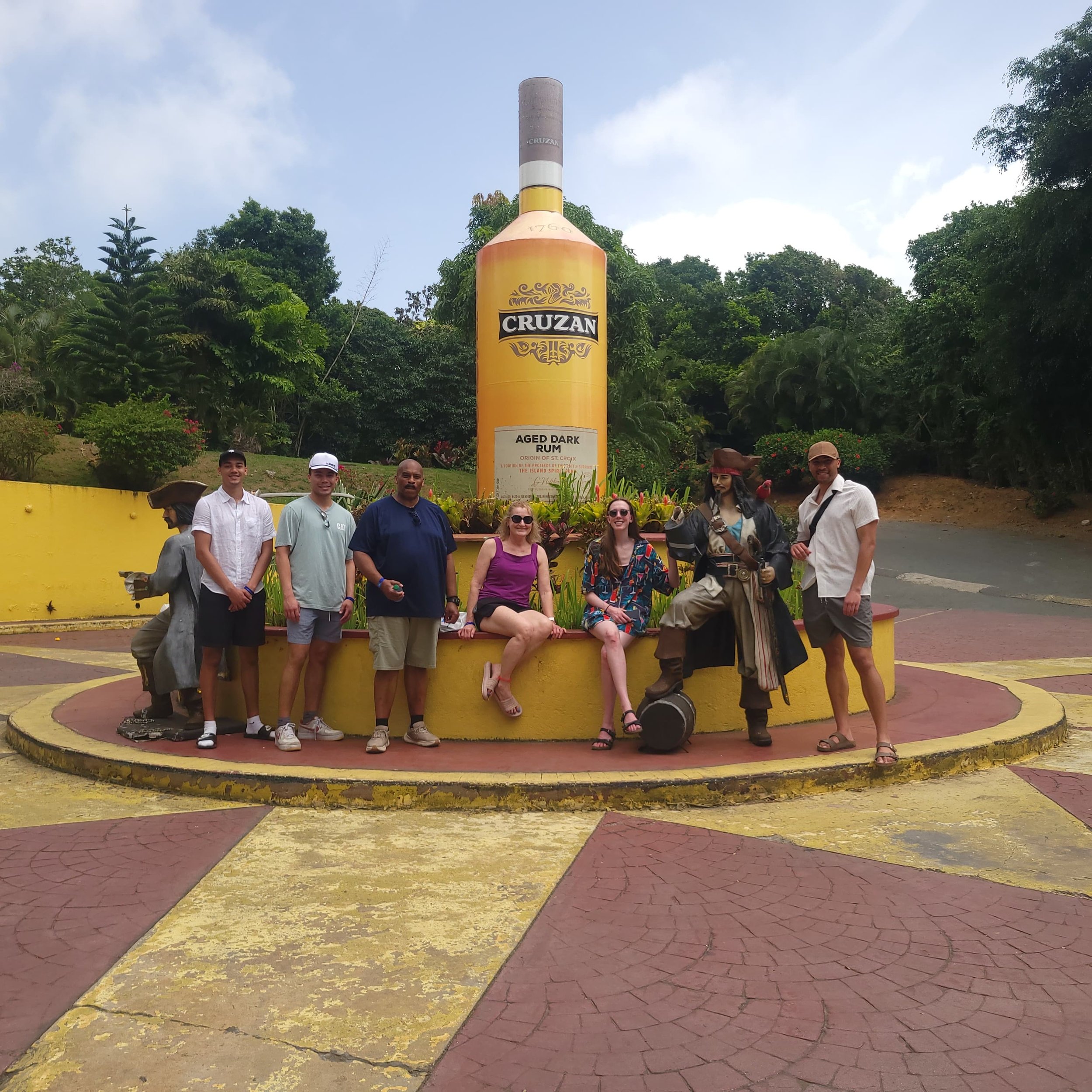 Big family, big smiles, and unforgettable island memories!   This group stopped at Mountain Top to capture a special moment beside the iconic Cruzan Rum bottle while enjoying their St. Thomas adventure with Jay’s Experience.