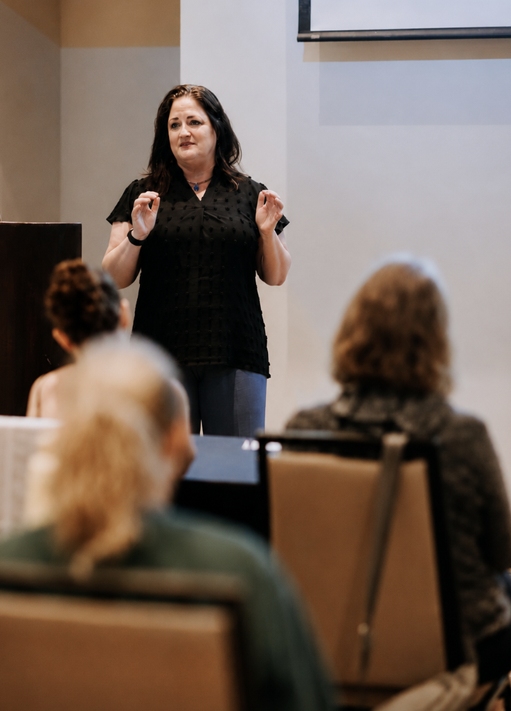 Melissa Russiano speaking on stage