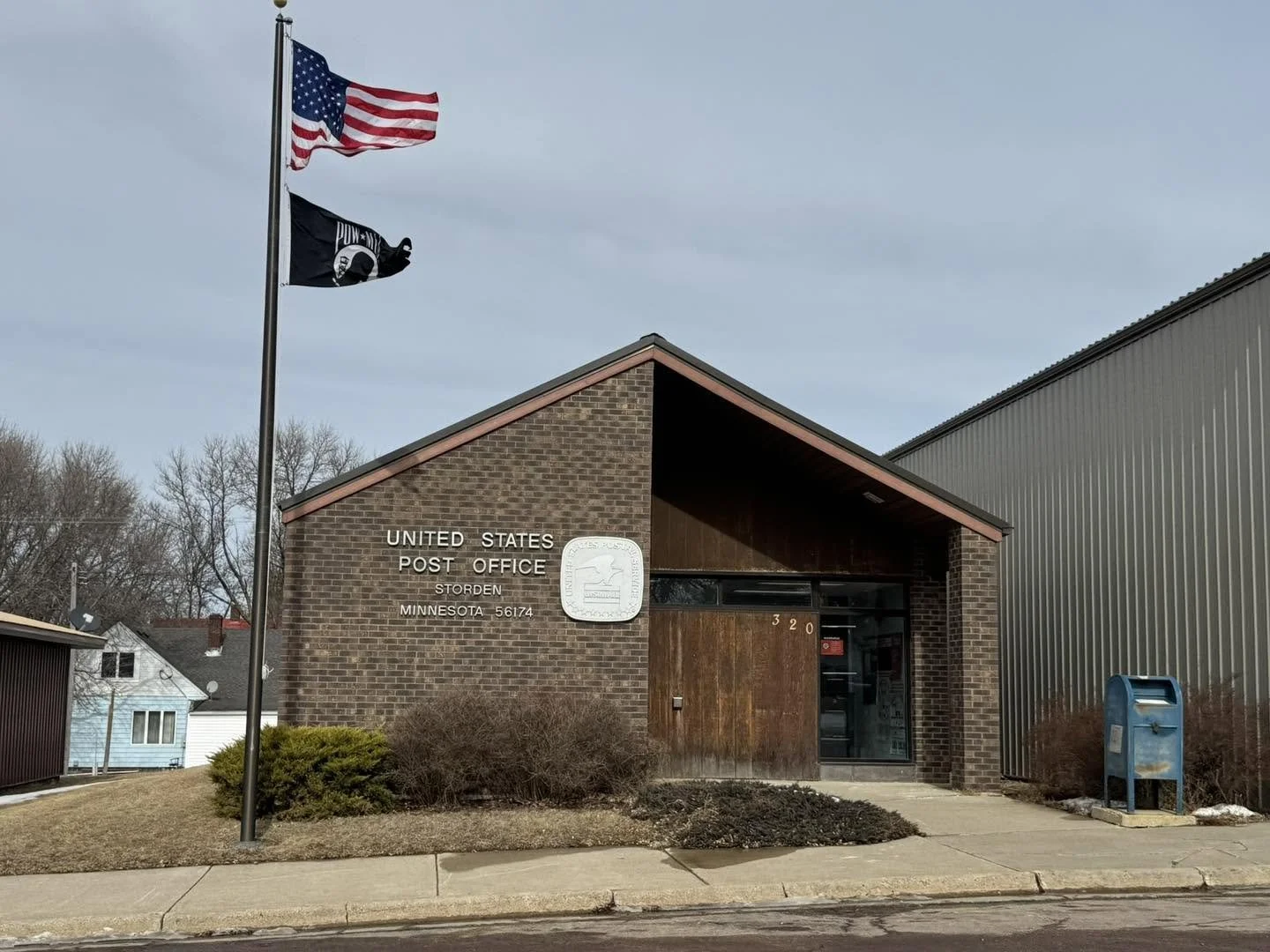 United States Post Office building in Storden, Minnesota with American flag and POW/MIA flag on flagpole