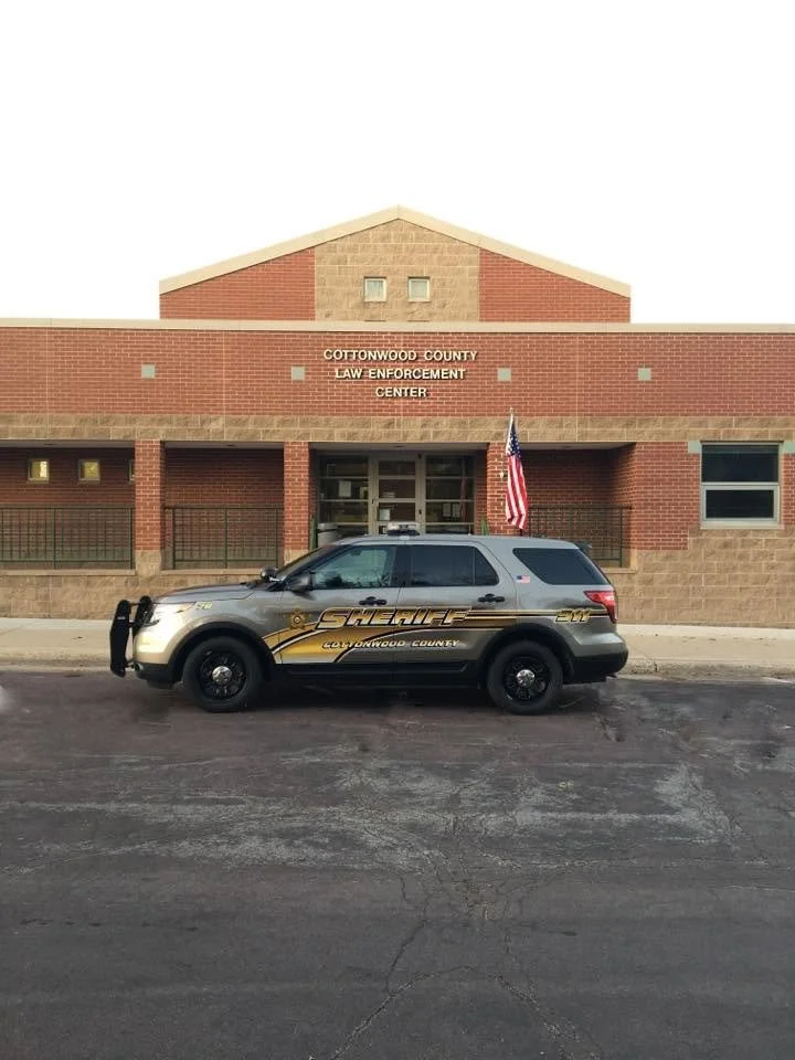A sheriff's vehicle parked in front of the Cottonwood County Law Enforcement Center building.