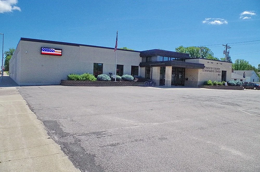 Woodford County Government Center building with American flag and parking lot.