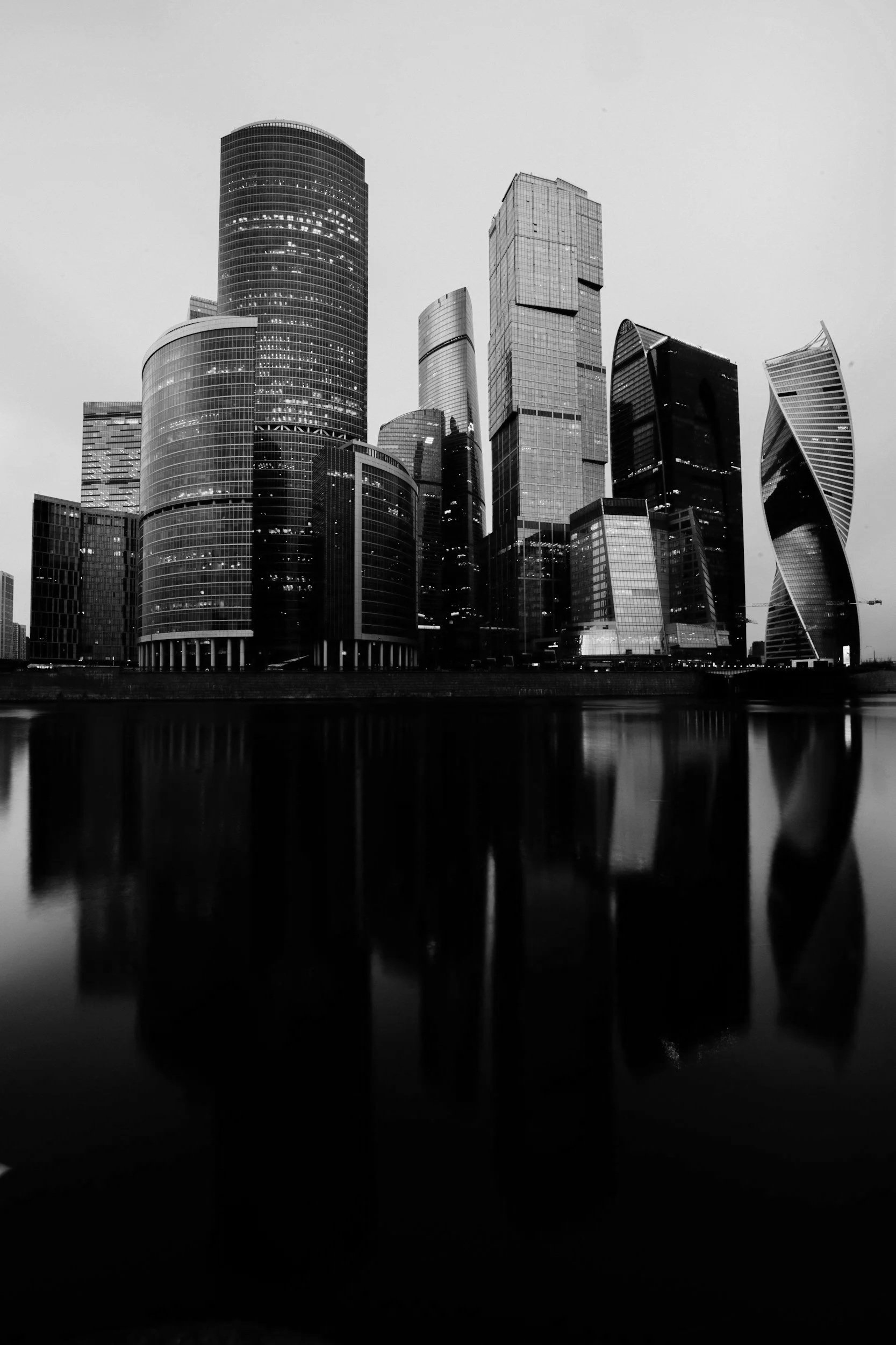 Black and white photo of a city skyline with tall modern skyscrapers.