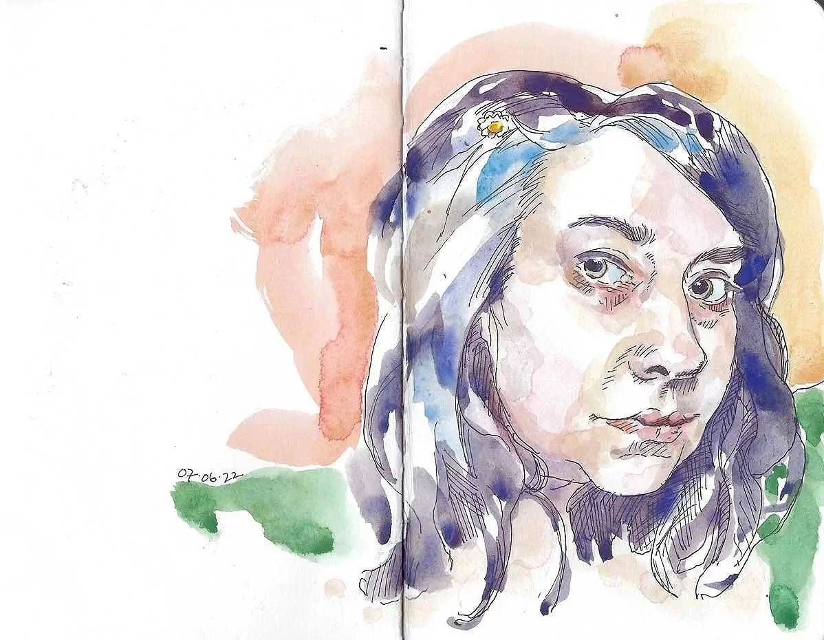 Watercolor portrait of a woman with long dark hair, gray eyes, and a calm expression. The background has soft orange, pink, and green washes.