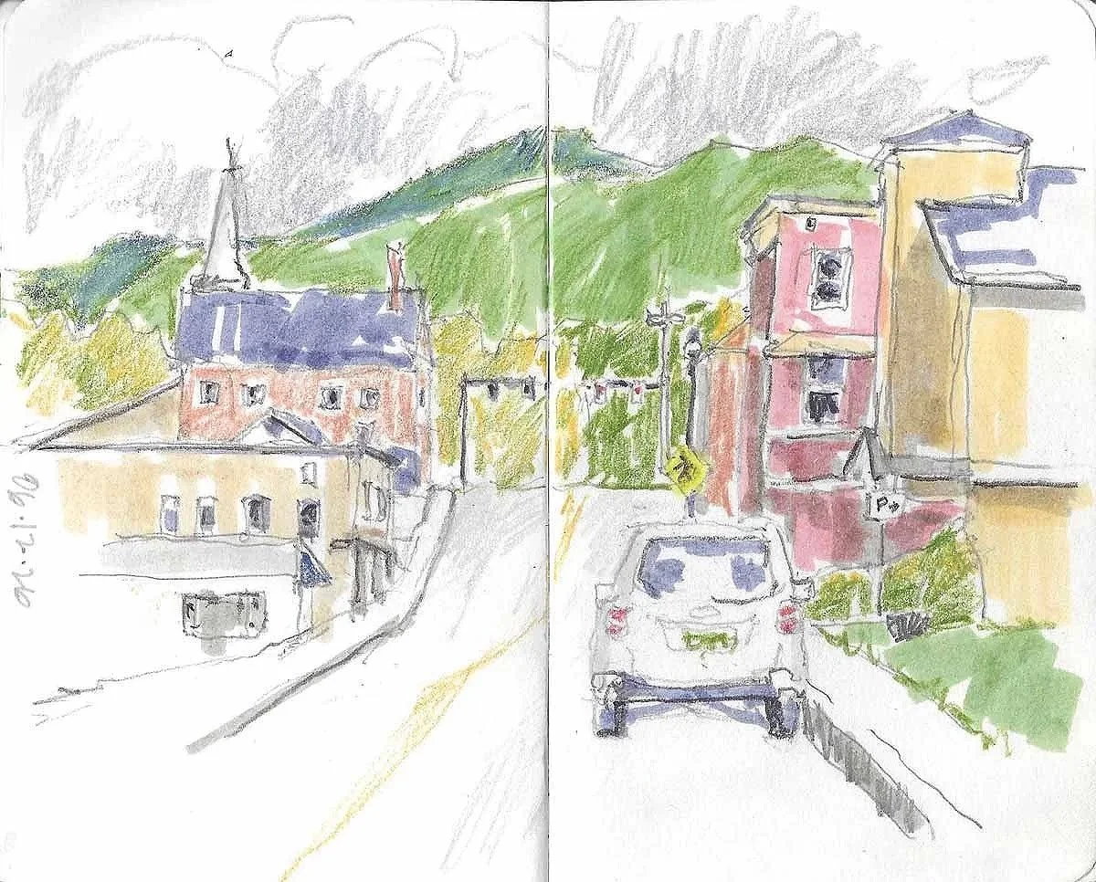 Watercolor sketch of a street scene with colorful buildings, a car, and green hills in the background.