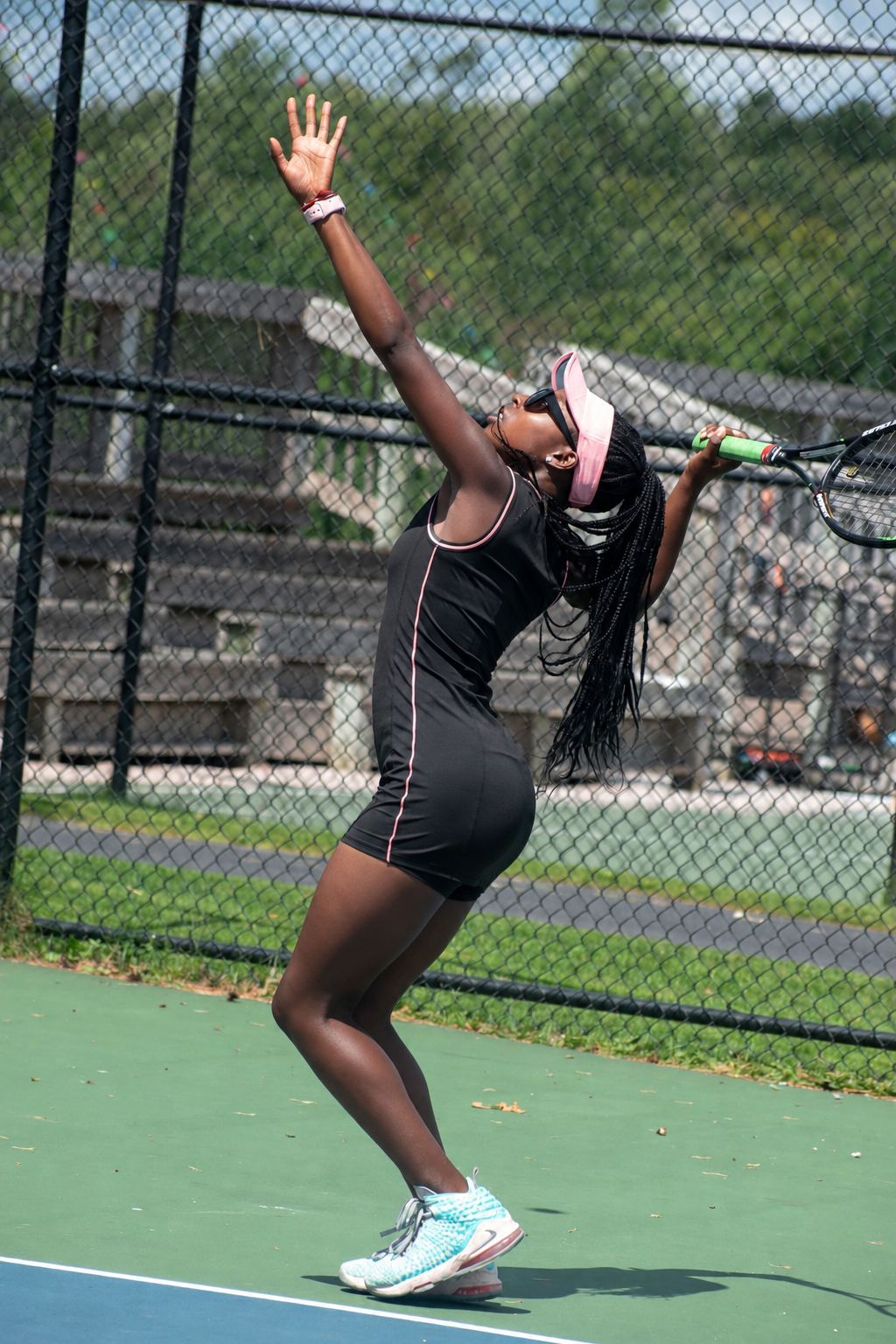 Makayla Butler serving during a tennis session