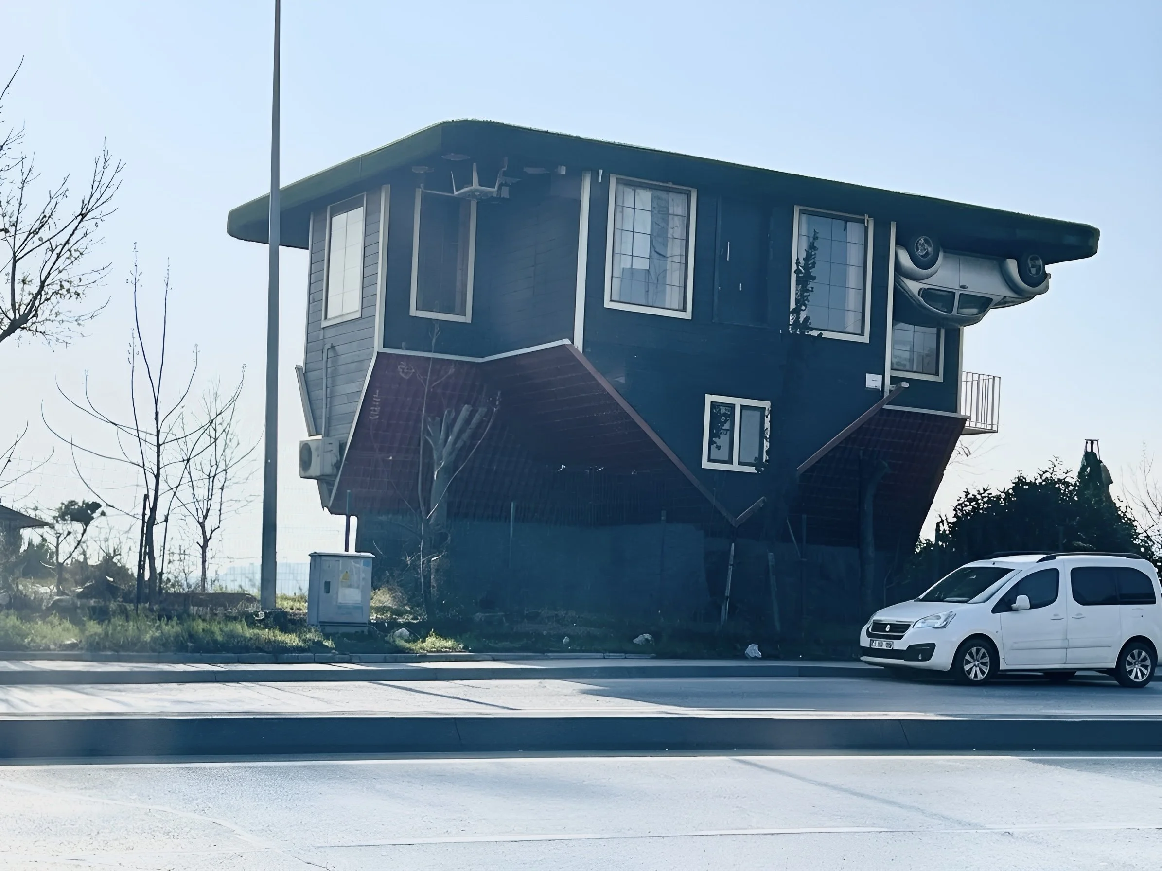 Upside-down house with a car mounted beneath its roof in Istanbul.