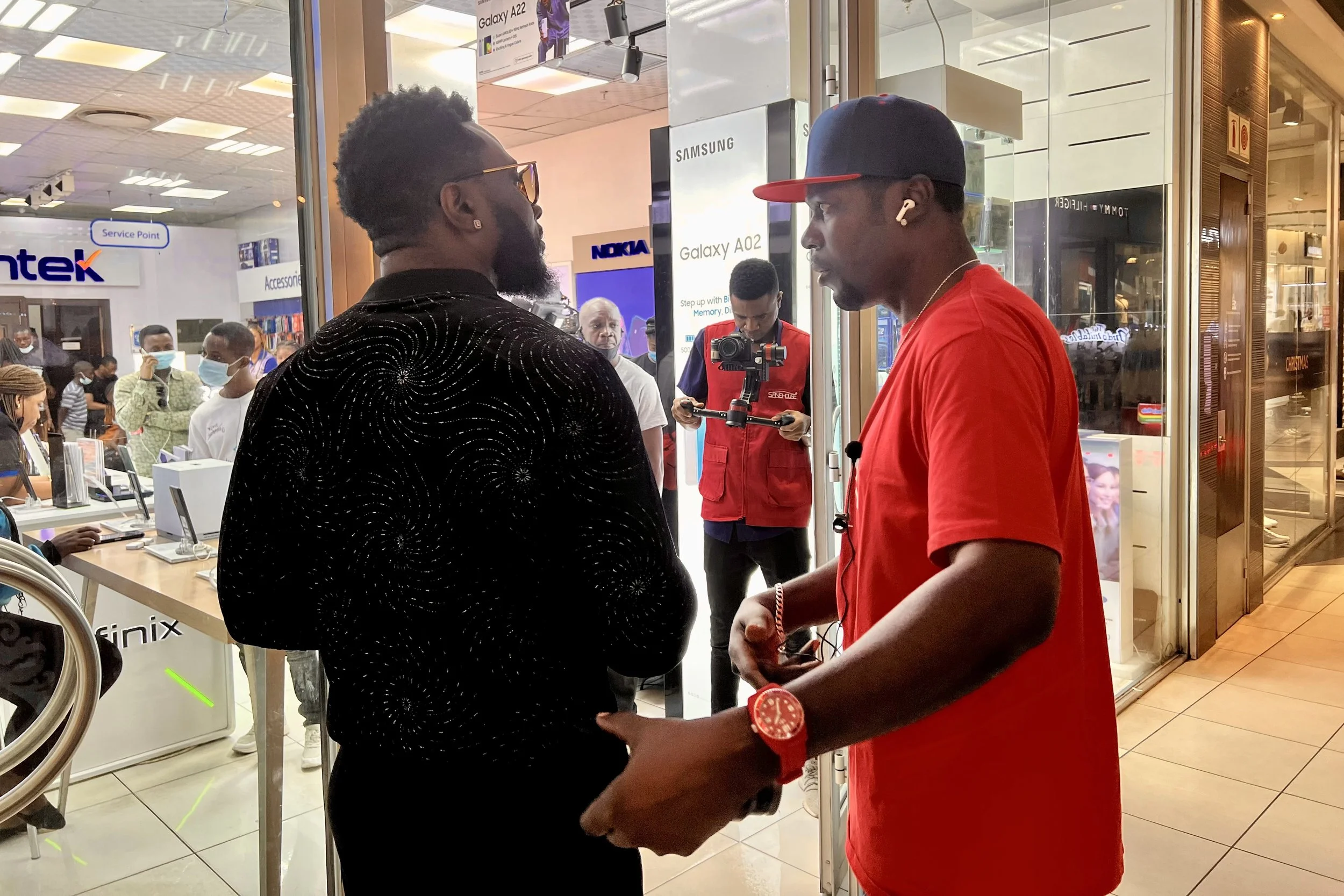 Sane House Media director giving instruction to a member of the cast at a video shoot.