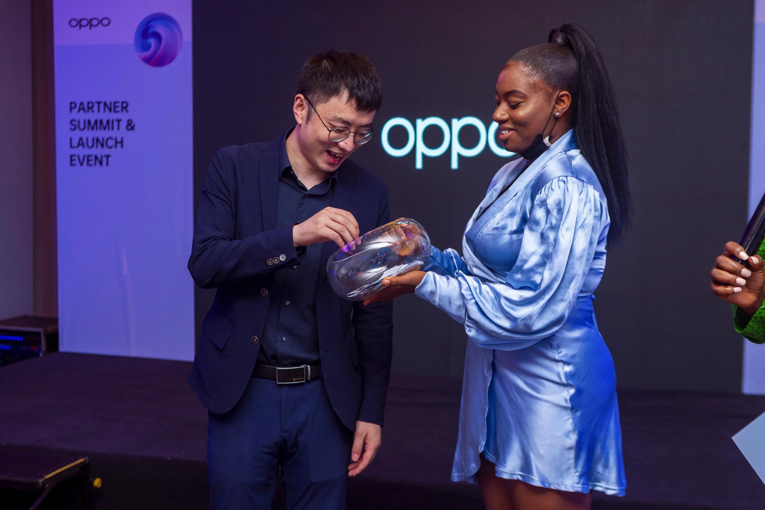 An usher and a staff  at an OPPO event, during a raffle draw.