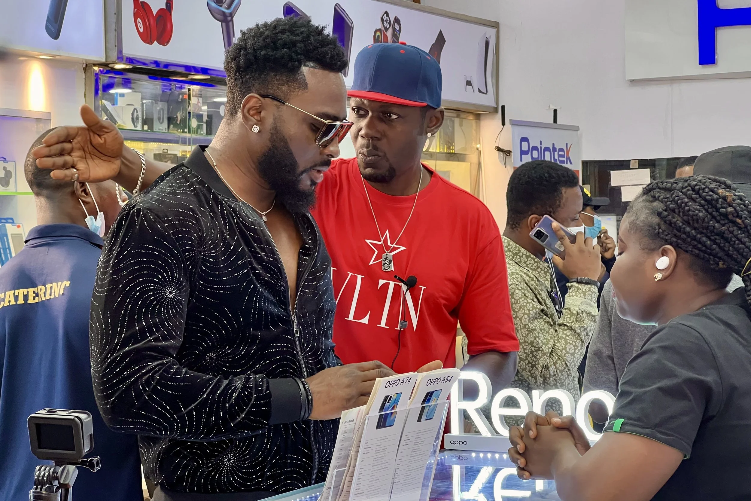 Sane House Media director giving instruction to a two member of the cast at a video shoot.
