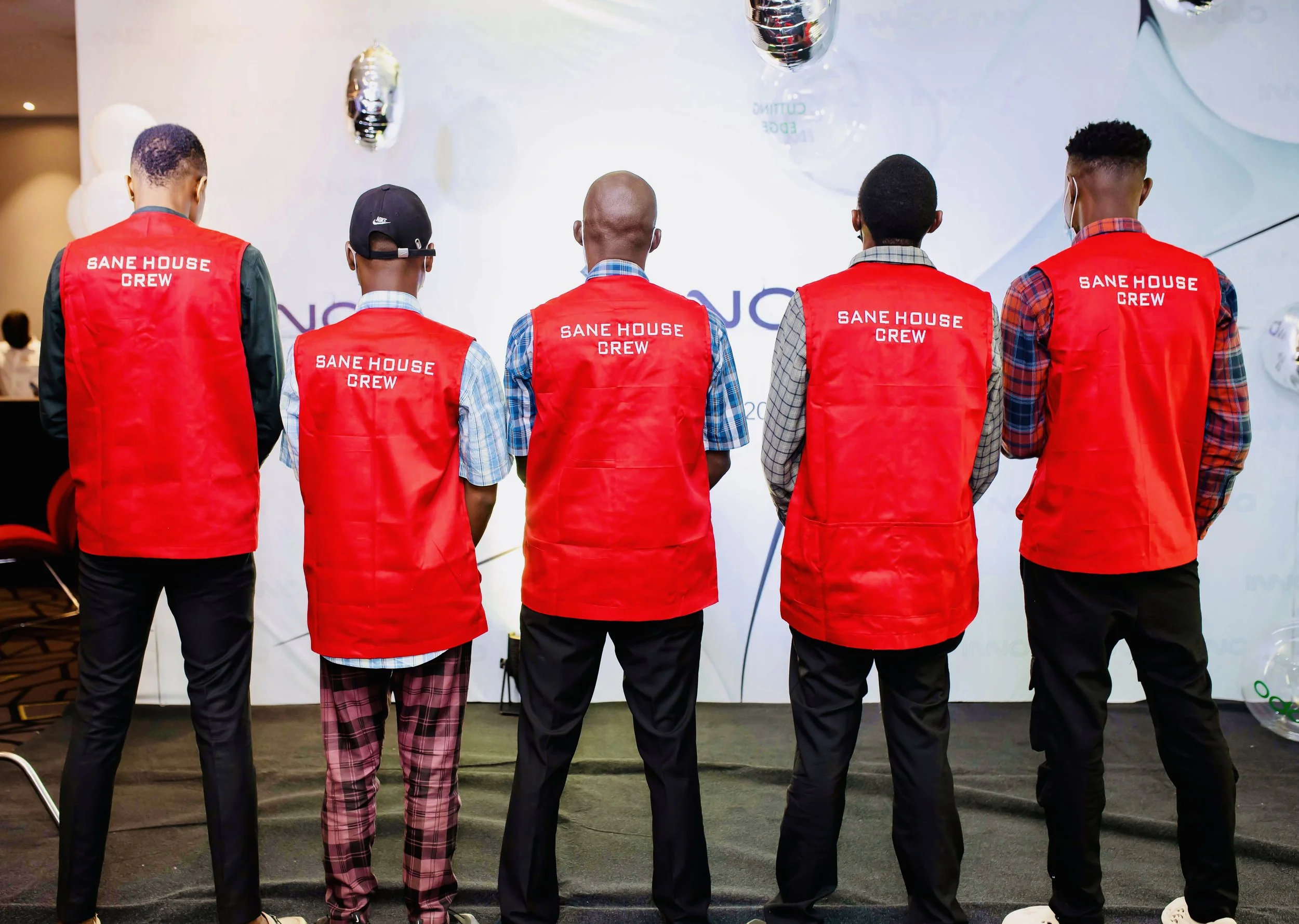 Sane House Media crew members wearing branded jackets during a production.