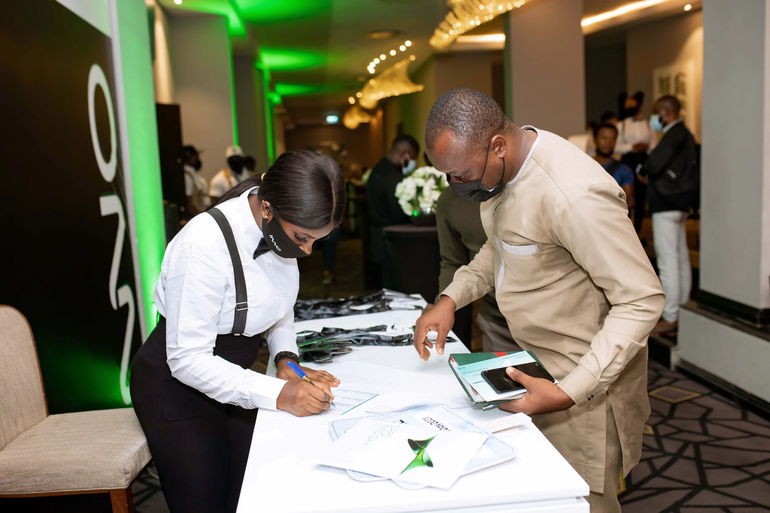 Guests wearing face masks during accreditation at an OPPO event.