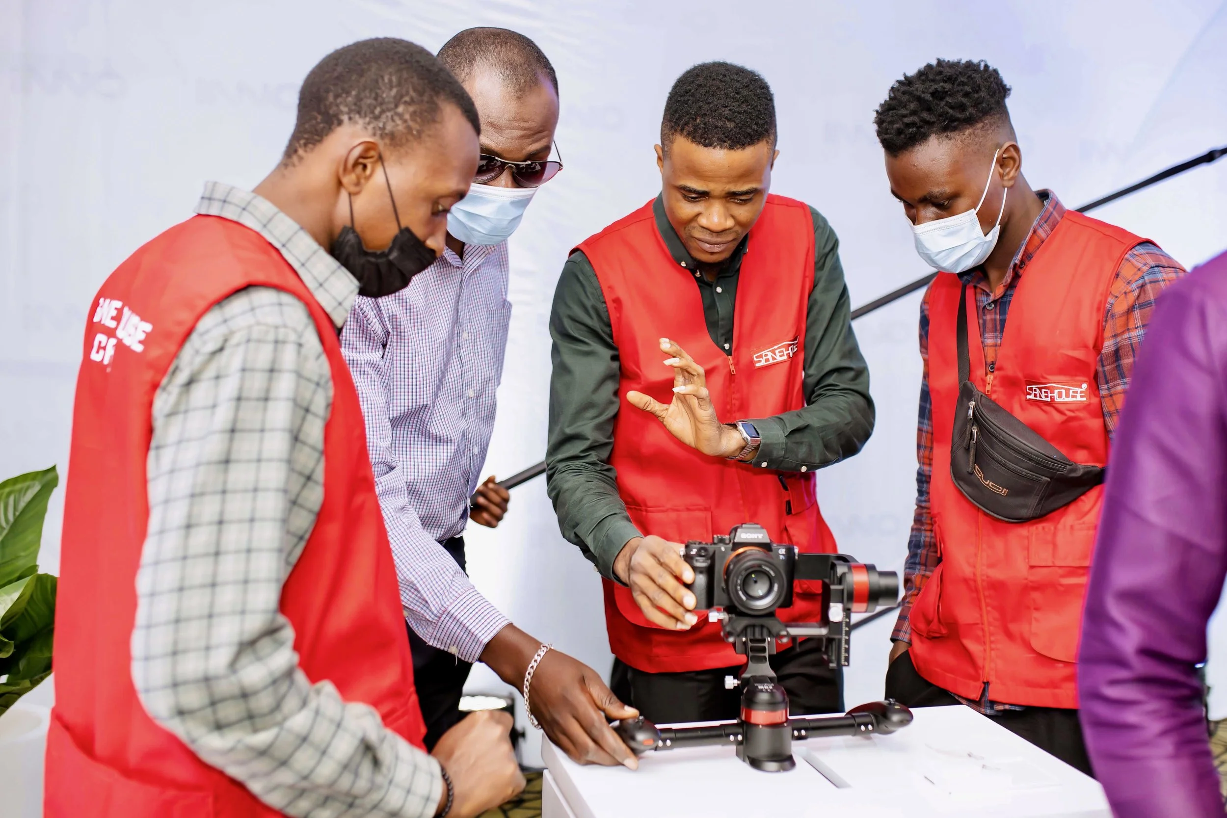 Sane House Media director and crew gathered around a professional camera mounted on a stabilizer.