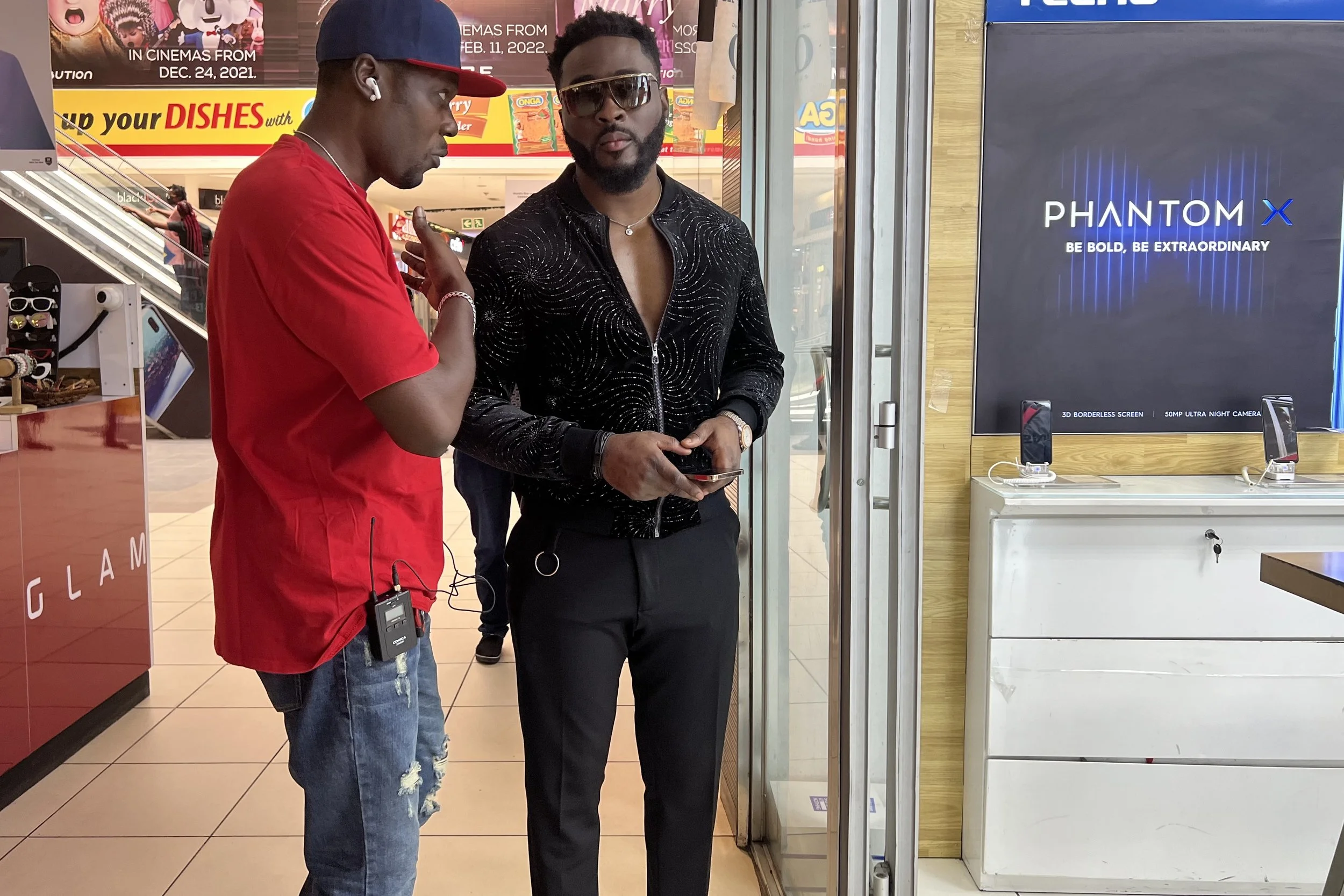 Sane House Media director giving instruction to a member of the cast at a video shoot.