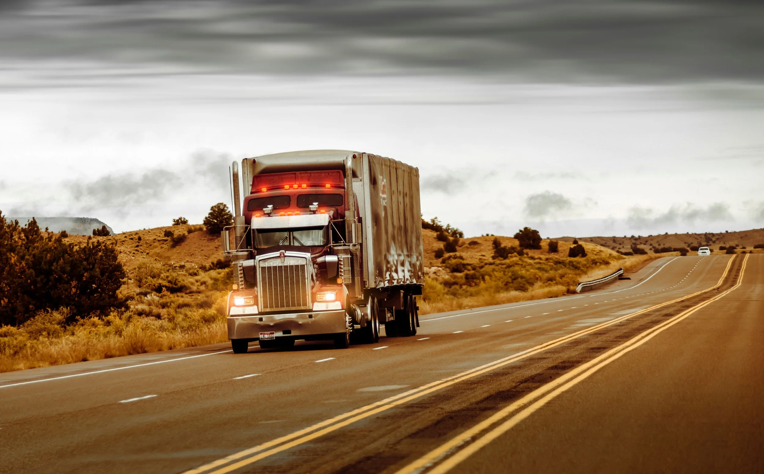 Texas CDL truck driver on open highway — independent driver life insurance options and benefits.