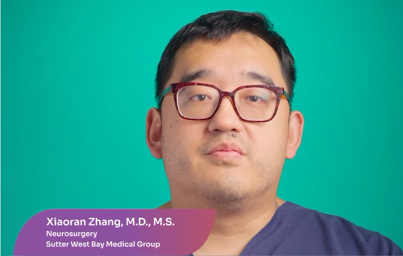 Portrait of Xiaoran Zhang, M.D., M.S., a neurosurgery doctor at Sutter West Bay Medical Group, wearing glasses and a dark shirt, with a green background.