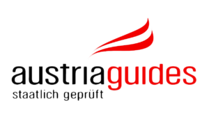 Logo of Australia Guides featuring a stylized red and white flame or wave above the text 'australia guides' with the tagline 'reader guides' beneath it.