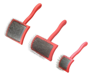 Three dog grooming brushes with pink handles in different sizes.