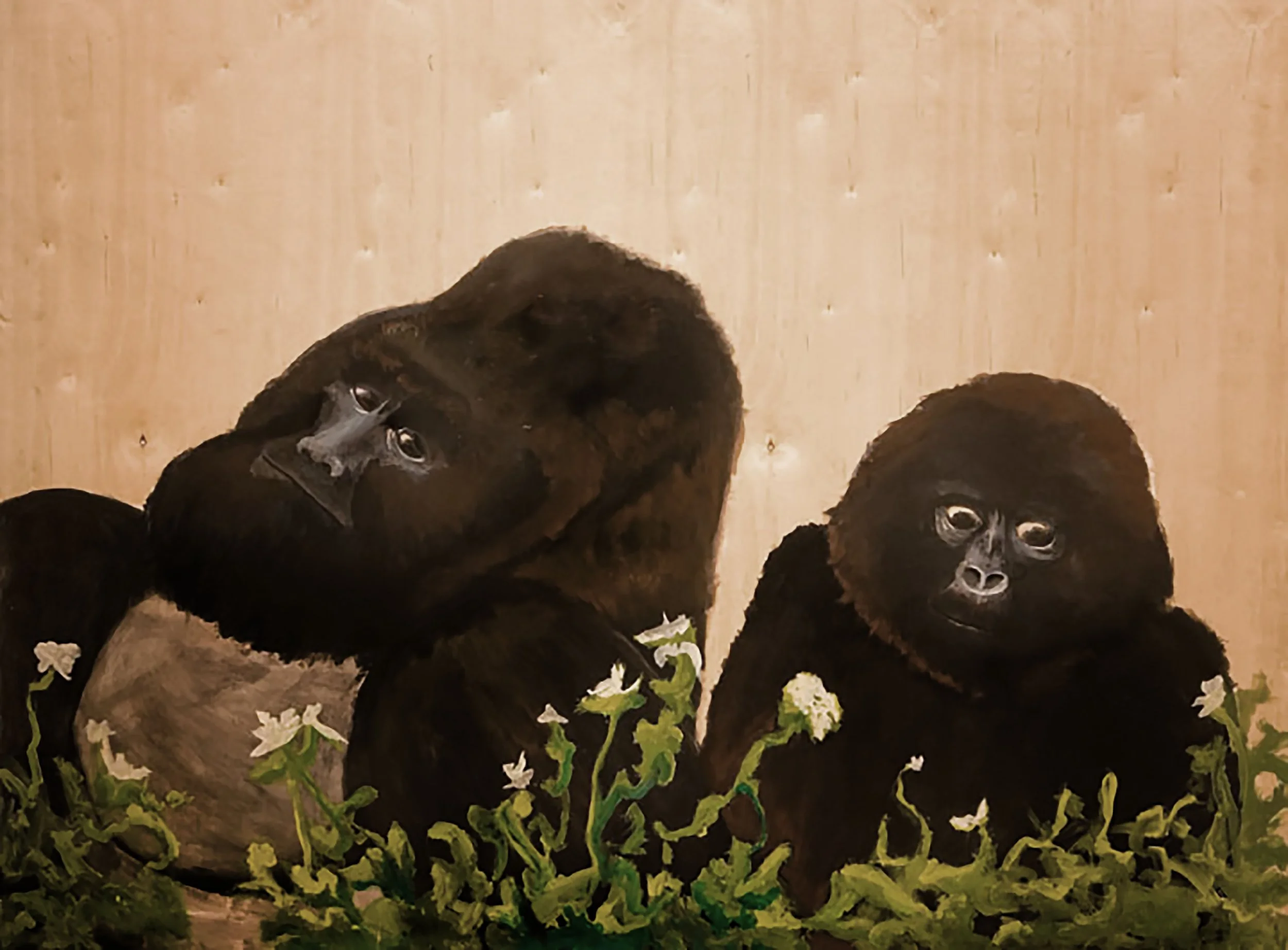 Close-up of a gorilla with expressive eyes and a nose job surrounded by white flowers and green foliage, set against a wooden background.
