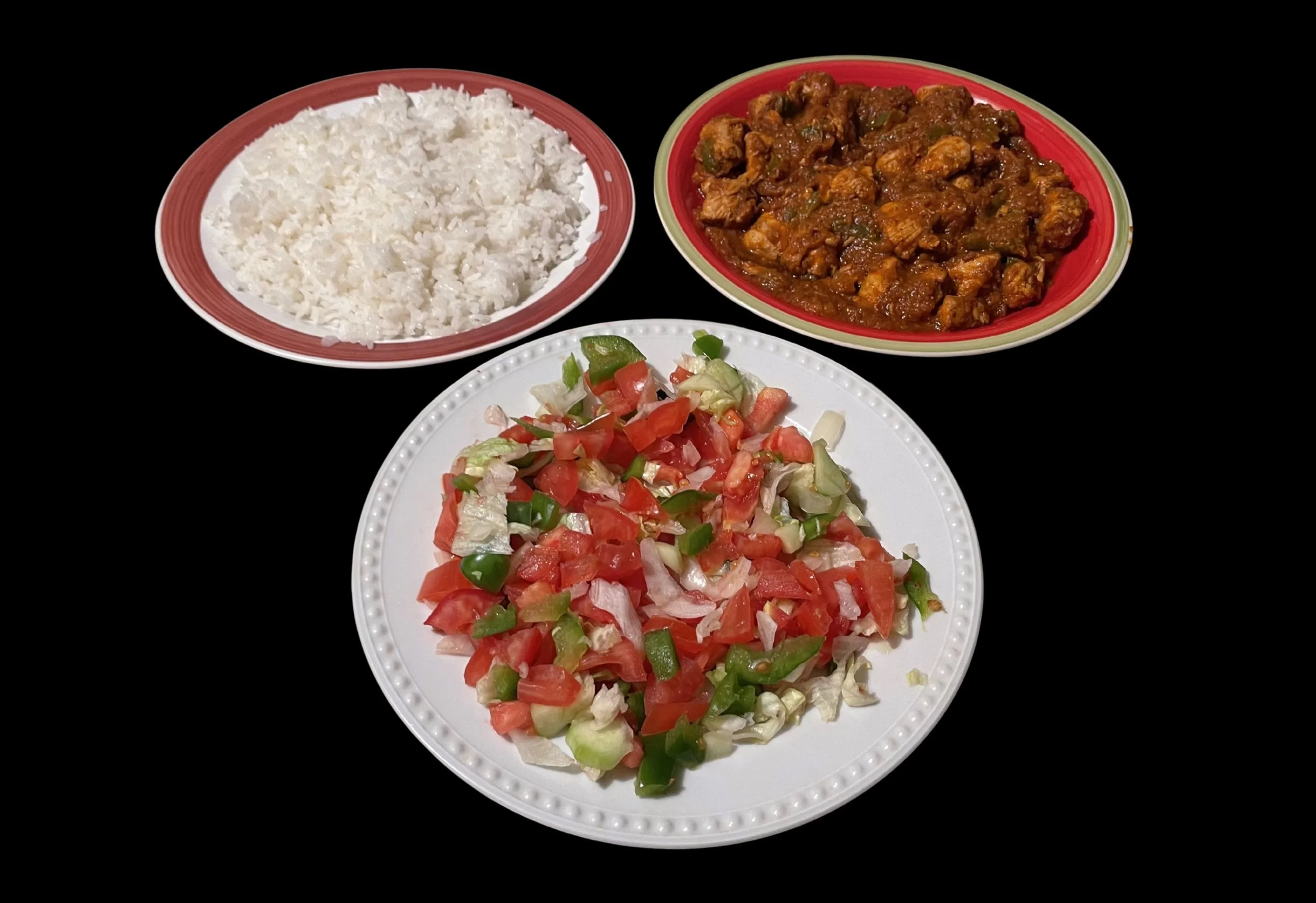 Chicken topped on rice with a side of salad