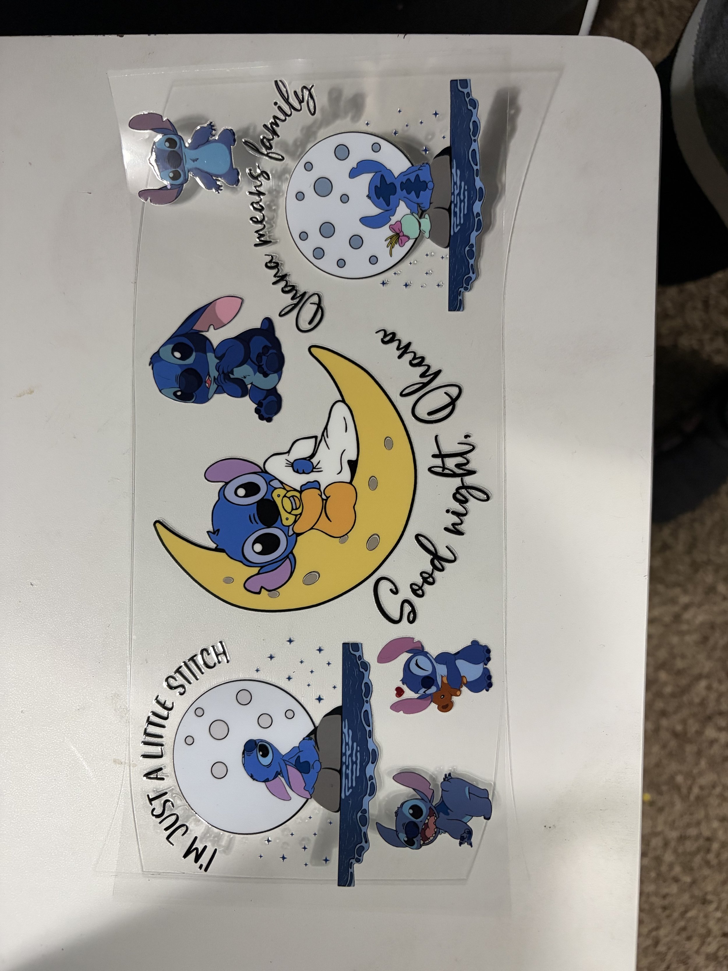 A sheet of stickers featuring Stitch from Disney's Lilo & Stitch in various poses and settings, including sitting on a crescent moon, with some stickers including a pool, a moon, and the phrase "I mustache you a question, but I stitch".