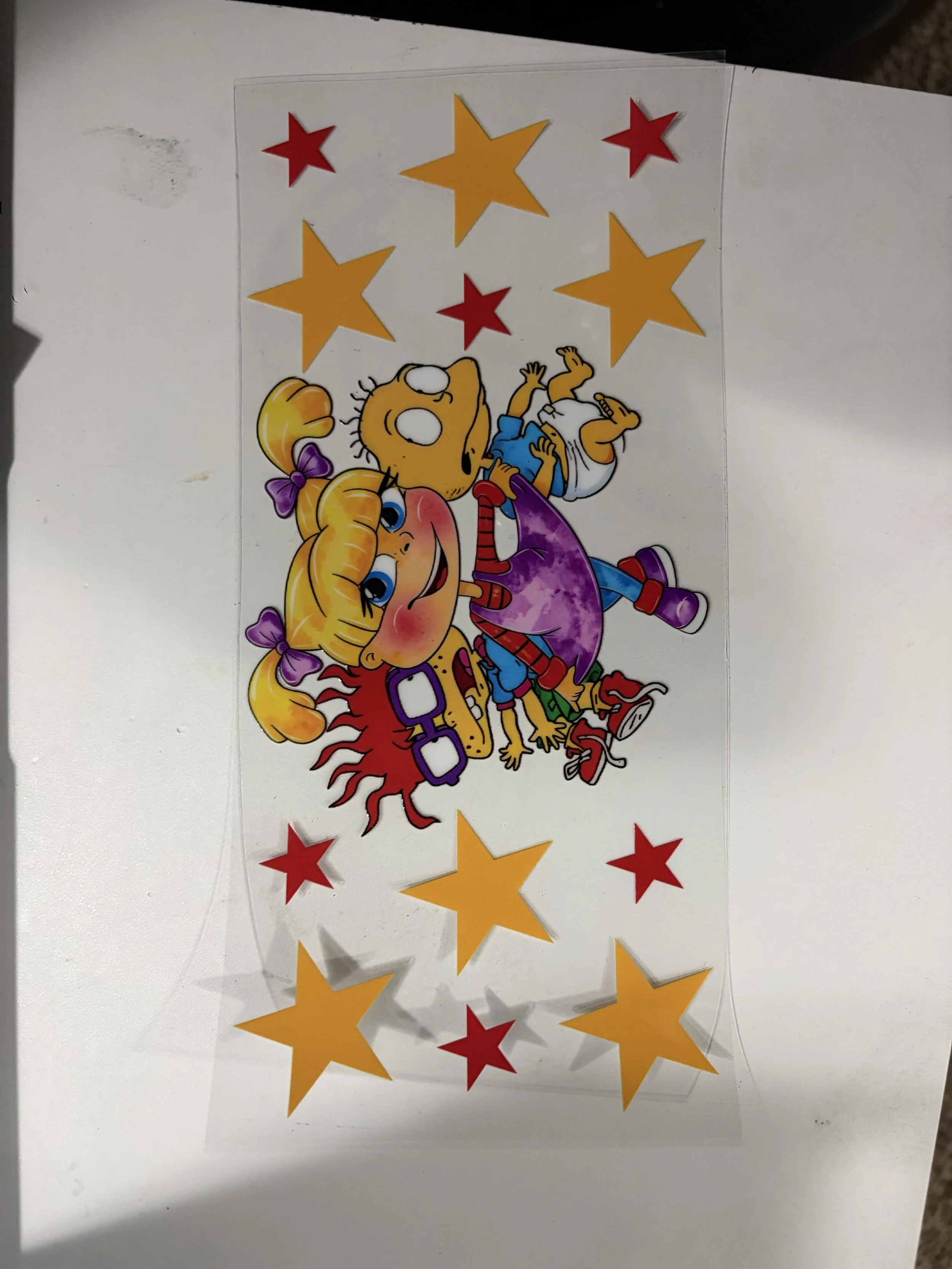 A colorful birthday card with cartoon characters, red and yellow stars, and decorative elements.