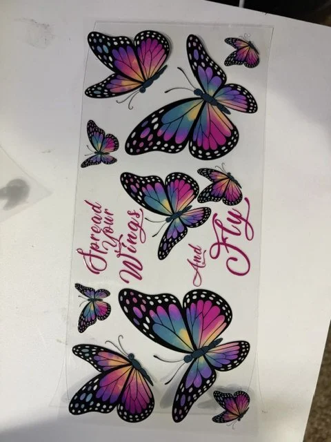 Sticker sheet featuring colorful butterflies with pink, purple, blue, and yellow wings and the text "Friend of your Wings and your Fly" written in pink calligraphy.
